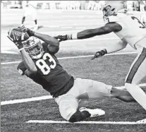  ?? DARRON CUMMINGS/AP ?? Chase Claypool makes one of his four touchdown receptions as Cameron Kinley defends Saturday in Notre Dame’s victory over Navy.