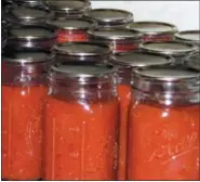 ?? LEE REICH VIA AP ?? This undated photo shows canned tomatoes in jars in New Paltz, N.Y. A pot of tomatoes, cooked down, blended, and then canned, brings some summer-y flavor to the dead of winter.