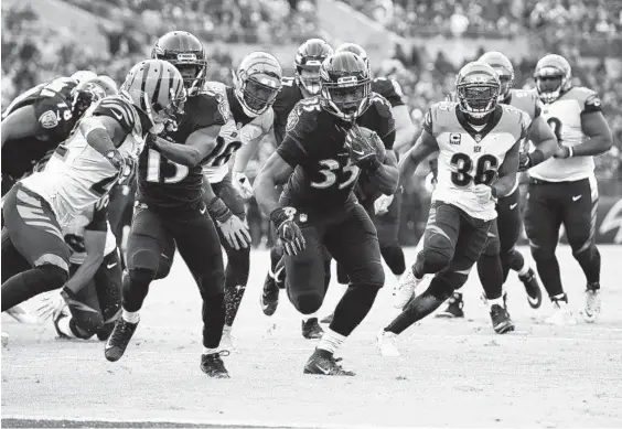  ?? GAIL BURTON/ASSOCIATED PRESS ?? Ravens rookie running back Gus Edwards carried the ball 17 times against the Bengals on Sunday after getting only 15 carries all season heading into the game.