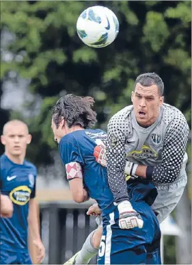  ??  ?? Follow through: City goalkeeper Tamati Williams punches the ball as he collides with captain Ivan Vicelich