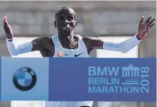  ?? AFP ?? Kenya’s Eliud Kipchoge heads for the finishing line to win the Berlin Marathon in a world-record time yesterday