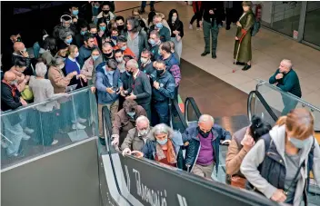  ?? AFP ?? Patients arrive to receive a dose of a Covid-19 vaccine at a vaccinatio­n centre in a shopping mall of Belgrade on Thursday. Serbia’s president said that his country would pay each citizen who gets a Covid jab before the end of May, in what could be the world’s first cash-for-jabs scheme. —