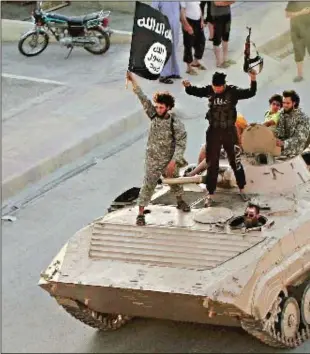  ??  ?? IS fighters parade along a street in Syria’s Raqqa province. The group controls