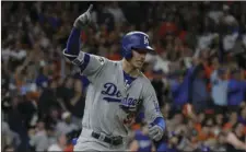  ?? AP PHOTO/ DAVID J. PHILLIP ?? Los Angeles Dodgers’ Cody Bellinger reacts after hitting an RBI double during the ninth inning of Game 4 of baseball’s World Series against the Houston Astros on Saturday in Houston.