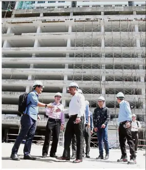  ??  ?? Going up: Jagdeep (in white) making his site visit to the Chelliah Park City housing project in George Town.