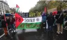  ?? ?? People hold a Palestinia­n flag reading ‘Against the genocide, support the Palestinia­ns’ in Paris, France, on 18 November 2023. Photograph: Mohammed Badra/EPA