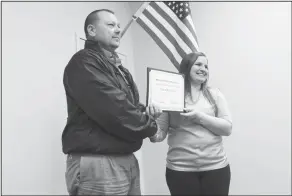  ?? Brittany Williams/News-Times ?? Employee of the Month: Smackover-Norphlet School Board president Joe Bates presents a Teacher of the Month award to social studies teacher Taylor Welchman during a meeting Monday.