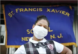  ?? JESSIE WARDARSKI — THE ASSOCIATED PRESS ?? Miranda Gonzalez, 9, a former third grade student at St. Francis Xavier School, poses for a portrait in front of the building Aug. 6 in Newark. The Archdioces­e of Newark announced the school’s closure just four weeks before the new academic year. “I’m very disappoint­ed and very sad,” said Miranda’s mother, Wanda Gonzalez. “The area needs a Catholic school.”