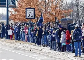 ?? KYLE ROBERTSON / THE COLUMBUS DISPATCH ?? Crowds line the streets as Westervill­e Police escort the bodies of Westervill­e police officers Eric Joering and Anthony Morelli to the Moreland Funeral Home.