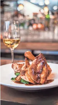  ?? TNS ?? At the Lucky Rooster, chef Clayton Rollison specialize­s in food with “Southern soul” such as half-chicken, fried or roasted.