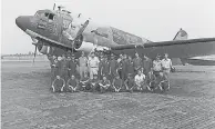  ?? FAMILY PHOTO ?? The writer’s father, Michael Moore, in the blue shirt in the back row, with his squadron at a U. S. military base in Thailand in 1973.