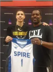  ?? BY JOHN KAMPF — THE NEWS-HERALD ?? LaMelo Ball shows off his new SPIRE basketball uniform along with SPIRE coach Jermaine Jackson on Nov. 10 in Geneva.