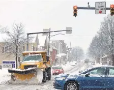  ??  ?? A Hellertown Public Works truck clears snow from Main Street in the borough on Monday.