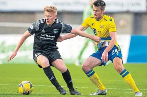  ??  ?? CUP BATTLE: Peterhead’s Andrew McCarthy, left, is challenged by Callum Booth of St Johnstone at Balmoor.