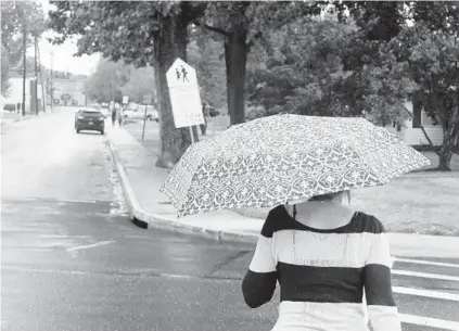  ?? MATT BUTTON/BALTIMORE SUN MEDIA GROUP ?? With her umbrella overhead, a woman makes her way to Bel Air Elementary School in Thursday’s rainy weather. Rainfall surpassed 3 inches in parts of the Baltimore region from Wednesday night through Thursday morning. About 2.5 inches fell at BWI Airport.