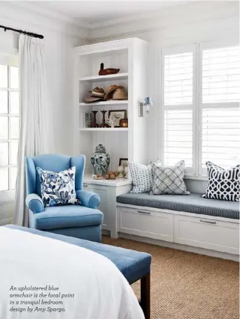  ?? ?? An upholstere­d blue armchair is the focal point in a tranquil bedroom design by Amy Spargo.
