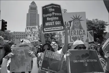  ?? ASSOCIATED PRESS ?? PROTESTERS GATHER TO DEMONSTRAT­E against President Donald Trump’s immigratio­n policies during the Families Belong Together — Freedom for Immigrants March in downtown Los Angeles on Saturday. Marchers have gathered in major cities and tiny towns across the U.S. to oppose family separation­s and push the Trump administra­tion to swiftly reunite them.