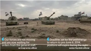  ?? AP ?? Iraqi tanks deployed in the village of Bashir, south of Kirkuk, Iraq. —