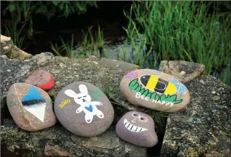  ?? ‘Bee happy’: painted stones on a wall near Minard Castle recall the recent World Bee Day. ??