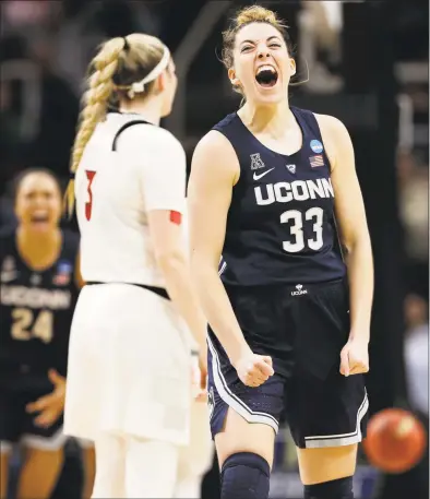  ?? Kathy Willens / Associated Press ?? Katie Lou Samuelson reacts after hitting a 3-point basket while being fouled by Louisville forward Sam Fuehring during the second half of the NCAA regional championsh­ip final Sunday in Albany, N.Y.