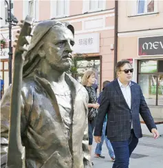  ??  ?? Saakashvil­i walks past a monument to Polish musician Tadeusz Nalepa in central Rzeszow, Poland. — Reuters photo