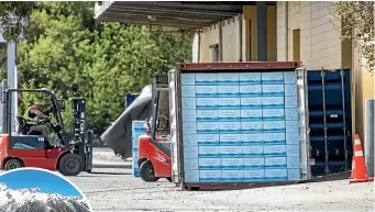  ?? DAVID WALKER/STUFF ?? A shipping container loaded with boxes of Cloud Ocean Water at the factory site in Belfast. Inset: The type of image used in Cloud Ocean’s promotiona­l videos.