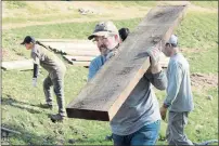  ?? ?? John Dimond of Fairfield carries a beam to the other side of the bridge, as it continued to be assembled.