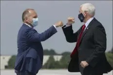  ?? Tim Tai/Philadelph­ia Inquirer via AP ?? U.S. Rep. Lloyd Smucker, left, R-Lancaster., greets Vice President Mike Pence as Mr. Pence arrives Thursday at Lancaster Airport in Lititz for a series of stops in Pennsylvan­ia.