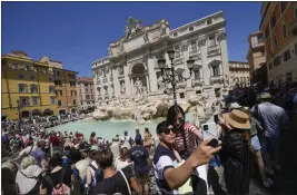  ?? ANDREW MEDICHINI — THE ASSOCIATED PRESS ?? Tourists take a selfie in front of the Trevi Fountain in Rome on Monday.