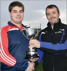  ??  ?? Colin Hawkins receives the cup from Paddy Murphy of Enniscorth­y Farm Systems (sponsors).