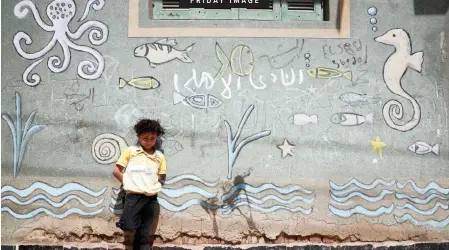  ?? | Reuters ?? A BOY stands in front of his house in Egypt’s Nile Delta fishing village of El Shakhluba, in the province of Kafr el-Sheikh.