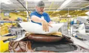  ?? STAFF FILE PHOTO BY TIM BARBER ?? Jeffery Godsey works as sub-upholstere­r and inserts polyuretha­ne foam into the standard La-Z-Boy recliner in Plant 6 at the Dayton facility.
