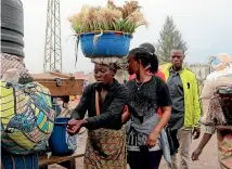  ?? AP ?? People wash their hands at the Congo side of the Poids Lourd checkpoint at the border between Congo and Rwanda.