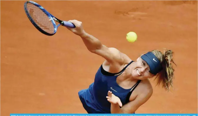  ?? —AFP ?? PARIS: Russia’s Maria Sharapova returns the ball to Czech Republic’s Karolina Pliskova during their women’s singles third round match on day seven of The Roland Garros 2018 French Open tennis tournament in Paris yesterday.