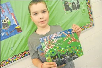  ?? tina coMEau ?? Grade 5 special needs student Cirdan MacLeod with a replica he painted himself of a Maud Lewis painting.