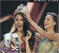 ??  ?? Catriona Gray of the Philippine­s, left, is crowned Miss Universe by her predecesso­r, South Africa’s Demi-Leigh Nel-Peters, in Bangkok, Thailand, yesterday, after Gray had edged out Miss South Africa, Tamaryn Green, right, |