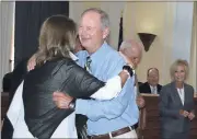  ?? Diane Wagner / Rome News-Tribune ?? Floyd Police Chief Bill Shiflett hugs County Commission­er Allison Watters after he was recognized for 42 years of service during the board’s employee pin ceremony Tuesday.