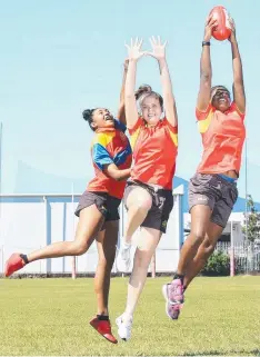 ??  ?? TALENT: Shantel Ripia, 16, Grace Perry, 17, and Kitara Farrar, 16, look forward to an opportunit­y in the AFL. Picture: JUSTIN BRIERTY