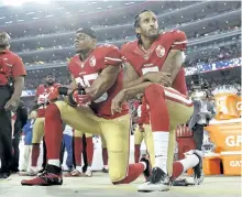  ?? THE ASSOCIATED PRESS FILES ?? San Francisco’s Eric Reid, left, and quarterbac­k Colin Kaepernick kneel during the national anthem in this September 2016 file photo.
