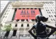  ??  ?? The “Fearless Girl” bronze sculpture looks towards the New York Stock Exchange on Sept. 10.