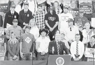  ?? DOUG MILLS NYT ?? Tyler Linfesty, who became known as Plaid Shirt Guy, looking incredulou­s behind U.S. President Donald Trump in Billings, Mont. last week during the president’s speech, gained widespread attention.