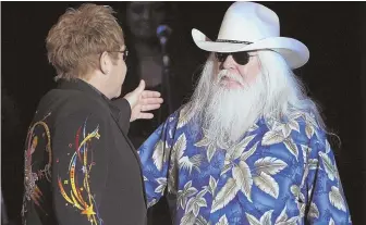  ?? AP FILE PHOTO ?? LEGENDS: Leon Russell, right, greets Elton John during a 2010 joint concert in Los Angeles. The Oklahoma-born Russell played with musical giants ranging from the Rolling Stones to Frank Sinatra during a career spanning almost 60 years.