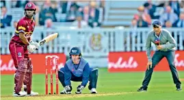  ??  ?? Former England captain Nasser Hussain doing on field commentary during the special fundraisin­g T20 Internatio­nal match between the West Indies and the Rest of the World at Lord’s in London on Thursday.