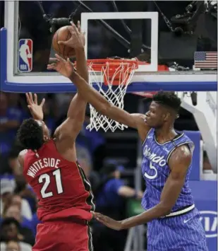  ?? JOHN RAOUX — THE ASSOCIATED PRESS ?? Miami’s Hassan Whiteside (21) goes up for a shot against Orlando rookie and Westtown School graduate Mohamed Bamba (5) on Wednesday in Orlando, Fla.