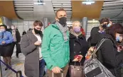  ?? MSTYSLAV CHERNOV/ASSOCIATED PRESS ?? Alexei Navalny and his wife, Yuliastand, stand in line at passport control after arriving at Sheremetye­vo Internatio­nal Airport, outside Moscow, on Sunday. Navalny was arrested shortly afterward.