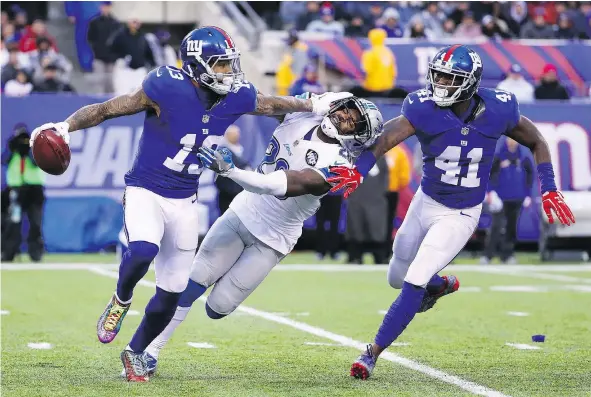  ?? — GETTY IMAGES ?? New York Giants wide receiver Odell Beckham Jr. gives a stiff arm to Don Carey of the Detroit Lions during a 17-6 victory Sunday at East Rutherford, N.J. that improved New York’s record to 10-4 on the season and moved the team closer to a playoff berth.