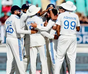  ?? AFP photo ?? India’s players celebrate after the dismissal of England’s captain Ben Stokes during the fourth day of the third Test cricket match between India and England at the Niranjan Shah Stadium in Rajkot. —