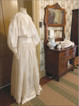  ?? (Courtesy Photo/RHM) ?? “For the exhibit we have a number of interestin­g artifacts that help illustrate what an early 1900s courtship might have been like,” says Rachel Smith, assistant director of the Rogers Historical Museum and curator of the “Etiquette of Courtship” exhibit in the Hawkins House. “We have a small collection of historic Valentines cards, as well as sheet music for love songs, and women's magazines from the period. We also have a wedding announceme­nt from 1910, and a wedding dress from 1908 that would have made part of the woman's trousseau — the items she took with her when she married. All of these give us a glimpse into ideas about love and courtship in the early 1900s.”