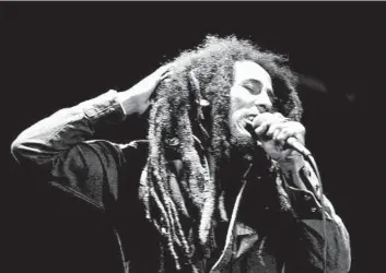  ?? Jacques Langevin Associated Press ?? JAMAICAN REGGAE singer Bob Marley performs in front of an audience of 40,000 at a 1980 music festival.