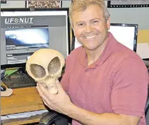  ??  ?? GOT ONE! UFO investigat­or Chuck Zukowski displays a possibly-not-genuine alien skull at his Colorado home.